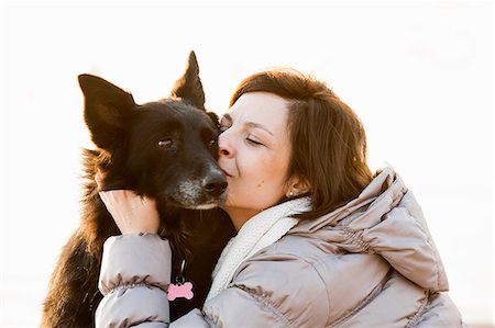 ski jacket - Close up of mid adult woman kissing her dog Stock Photo - Premium Royalty-Free, Code: 649-08125931