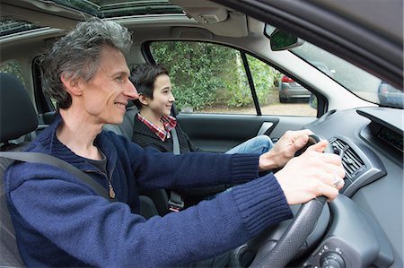 Mature man driving car with teenage son Stock Photo - Premium Royalty-Free, Code: 649-08125956