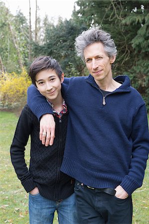 father son portrait home - Portrait of mature man and teenage son in garden Stock Photo - Premium Royalty-Free, Code: 649-08125953