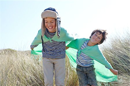 simsearch:614-09210071,k - Two young boys, wearing fancy dress, playing on beach Stock Photo - Premium Royalty-Free, Code: 649-08144181