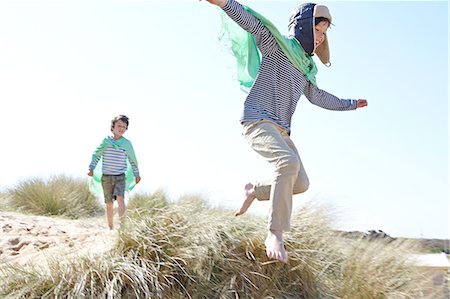 Two young boys, wearing fancy dress, playing on beach Stock Photo - Premium Royalty-Free, Code: 649-08144182