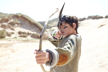 simsearch:649-07585487,k - Young boy wearing fancy dress, holding home-made bow and arrow Stock Photo - Premium Royalty-Free, Code: 649-08144205