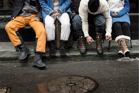 Friend sitting on bench, man tying shoelaces Stock Photo - Premium Royalty-Free, Code: 649-08144259