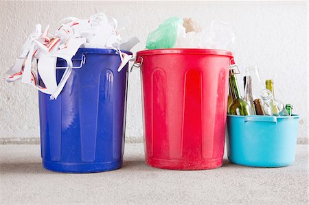 environmental conservation still life - Three recycling buckets in garage with paper, bottles and plastic Stock Photo - Premium Royalty-Free, Code: 649-08144280