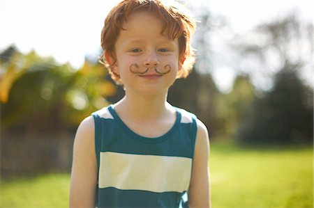 redheaded boy - Portrait of young boy with drawn on moustache Stock Photo - Premium Royalty-Free, Code: 649-08144395