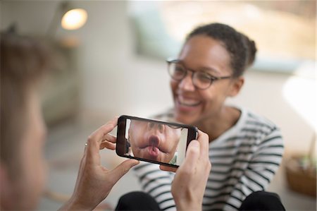 digital imaging - Person holding smartphone, woman laughing Stock Photo - Premium Royalty-Free, Code: 649-08144572