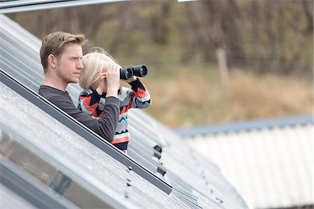 Father and son looking through rooflight, boy using binoculars Stock Photo - Premium Royalty-Free, Code: 649-08144604