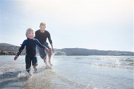 Father and son running on beach, Loch Eishort, Isle of Skye, Hebrides, Scotland Stock Photo - Premium Royalty-Free, Code: 649-08144621