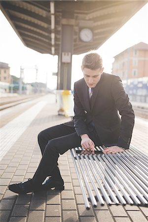 simsearch:649-08144794,k - Portrait of young businessman commuter using digital tablet at train station. Stock Photo - Premium Royalty-Free, Code: 649-08144806