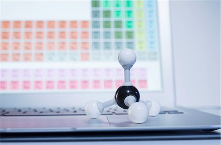 Chemistry research. A ball-and-stick methane molecule model on a laptop computer displaying periodic table elements Stock Photo - Premium Royalty-Free, Code: 649-08144853