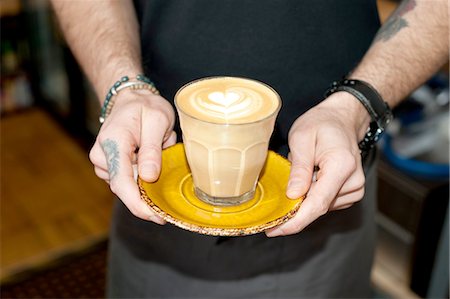 floral tattoo - Hands of cafe waiter serving fresh latte in glass Photographie de stock - Premium Libres de Droits, Code: 649-08145021