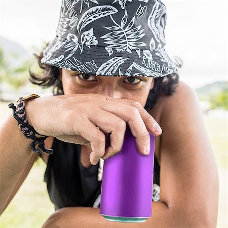 drinking can - Close up portrait of young man wearing sunhat drinking from can Stock Photo - Premium Royalty-Free, Code: 649-08145051