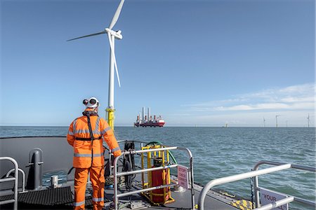 Crew member on deck of boat on offshore wind farm Stock Photo - Premium Royalty-Free, Code: 649-08145125