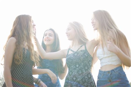 simsearch:649-08307526,k - Four teenage girls chatting in park Stock Photo - Premium Royalty-Free, Code: 649-08145148