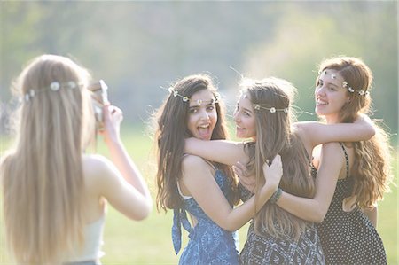 simsearch:649-08307526,k - Teenage girl photographing three friends using instant camera in park Stock Photo - Premium Royalty-Free, Code: 649-08145182