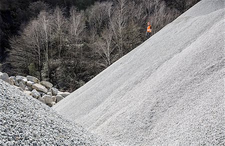 people working in mines - Quarry worker on gravel mound at quarry Stock Photo - Premium Royalty-Free, Code: 649-08145196