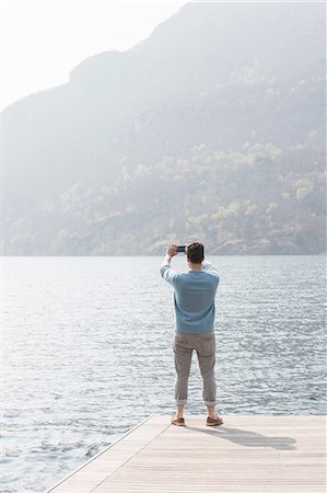 simsearch:649-08144840,k - Rear view of young man taking photograph from pier, Lake Mergozzo, Verbania, Piemonte, Italy Stock Photo - Premium Royalty-Free, Code: 649-08145653