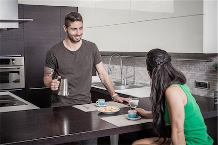 Young man pouring breakfast coffee for girlfriend Stock Photo - Premium Royalty-Free, Code: 649-08179944