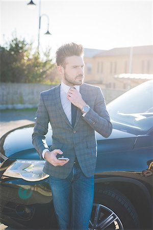 simsearch:614-08148375,k - Young businessman adjusting tie in car park Stock Photo - Premium Royalty-Free, Code: 649-08180078