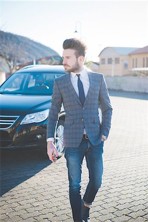 simsearch:649-08180080,k - Young businessman walking across parking lot Stock Photo - Premium Royalty-Free, Code: 649-08180081