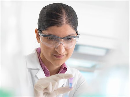 simsearch:649-08565304,k - Female scientist viewing sample in eppendorf ahead of DNA testing in a laboratory. Photographie de stock - Premium Libres de Droits, Code: 649-08180340