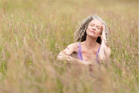 simsearch:649-07560073,k - Mature woman sitting in long grass with eyes closed Stock Photo - Premium Royalty-Free, Code: 649-08180489