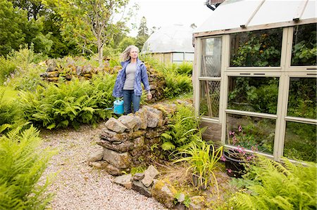 simsearch:649-08702075,k - Mature woman carrying watering can in garden Stock Photo - Premium Royalty-Free, Code: 649-08180529