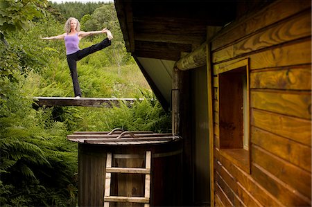 simsearch:649-07560073,k - Mature woman practicing yoga pose on footbridge at eco lodge Stock Photo - Premium Royalty-Free, Code: 649-08180556