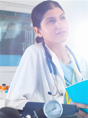 Female doctor contemplating medical notes in hospital Stock Photo - Premium Royalty-Free, Code: 649-08180607