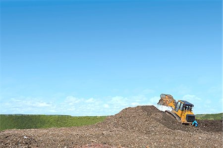 excavations - Digger on mound burying waste on landfill site Stock Photo - Premium Royalty-Free, Code: 649-08180689