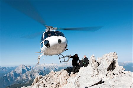 dangerous journey - Helicopter dropping BASE jumpers on mountain, Dolomites, Italy Stock Photo - Premium Royalty-Free, Code: 649-08180695