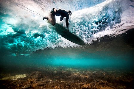 focus, determination - Underwater view of surfer falling through water after catching a wave on a shallow reef in Bali, Indonesia Stock Photo - Premium Royalty-Free, Code: 649-08237636