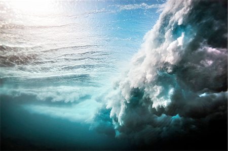 sunlight abstract - Low angle underwater view of huge wave crashing over a shallow reef Stock Photo - Premium Royalty-Free, Code: 649-08237638