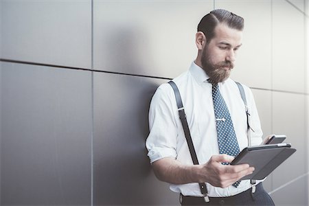 simsearch:649-08180080,k - Stylish businessman using digital tablet and smartphone outside office Stock Photo - Premium Royalty-Free, Code: 649-08237697