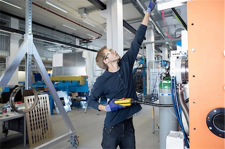 factory worker reaching - Factory technician testing control panel Stock Photo - Premium Royalty-Free, Code: 649-08237753