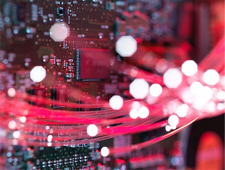 Fibre optics flowing through circuit boards from a laptop computer, close-up Stock Photo - Premium Royalty-Free, Code: 649-08237902