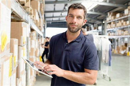 simsearch:693-06379352,k - Warehouse worker using digital tablet in distribution warehouse Stock Photo - Premium Royalty-Free, Code: 649-08237945