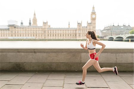 side view of woman jogging - Female runner running on Southbank, London, UK Stock Photo - Premium Royalty-Free, Code: 649-08238057