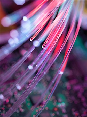 Fibre optics used to send data darting past computer circuit board Stock Photo - Premium Royalty-Free, Code: 649-08238124