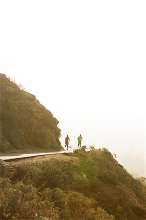 simsearch:649-06829432,k - Two male friends running along mountain path,rear view Stock Photo - Premium Royalty-Free, Code: 649-08238184