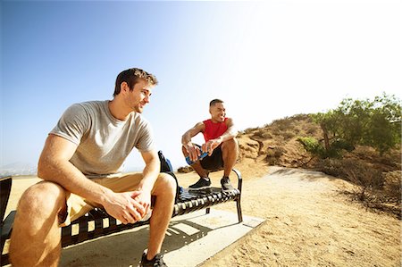 simsearch:649-08238188,k - Two male friends, sitting on bench, on cliff top, looking at view Foto de stock - Sin royalties Premium, Código: 649-08238191