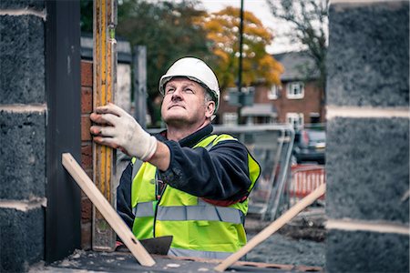 Workers laying bricks on construction site Stock Photo - Premium Royalty-Free, Code: 649-08238237