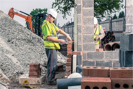 Workers laying bricks on construction site Stock Photo - Premium Royalty-Free, Code: 649-08238238