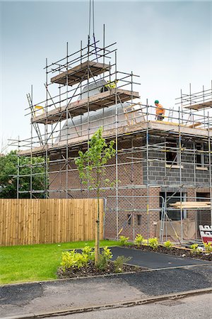 roofs construction industry - Construction worker on roof of building site Stock Photo - Premium Royalty-Free, Code: 649-08238256