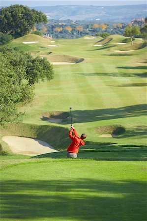 simsearch:400-04468744,k - High angle view of golf course and golfer taking golf swing Stock Photo - Premium Royalty-Free, Code: 649-08238379