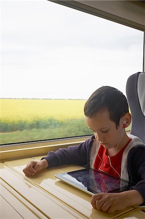 simsearch:649-07064289,k - Boy on train reading digital tablet Stock Photo - Premium Royalty-Free, Code: 649-08238524