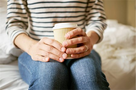 simsearch:693-08127560,k - Womans hands holding takeaway coffee on bed Stock Photo - Premium Royalty-Free, Code: 649-08238536