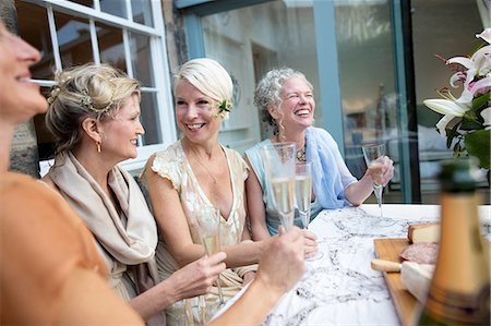 picture of champagne bottle and champagne flute - Elegant mature women enjoying champagne in urban garden Stock Photo - Premium Royalty-Free, Code: 649-08238924