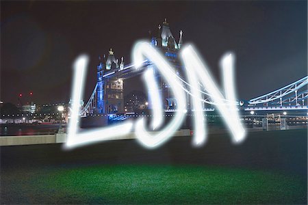 simsearch:649-08922723,k - Glowing abbreviated London symbol in front of Tower Bridge at night Foto de stock - Sin royalties Premium, Código: 649-08239124