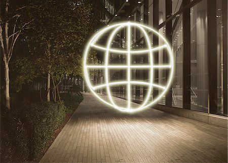 Glowing globe symbol in city at night Stock Photo - Premium Royalty-Free, Code: 649-08239123